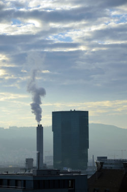 A picture of the ERZ power plant chimney and of the Prime Tower, both in Zurich (Switzerland)