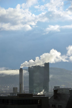 A picture of the ERZ power plant chimney and of the Prime Tower, both in Zurich (Switzerland)